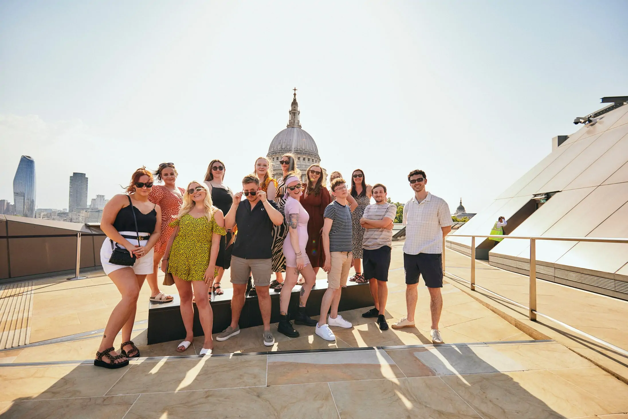 Accounts and Legal team stood in front of architecture. Be a part of this team by applying to our jobs.