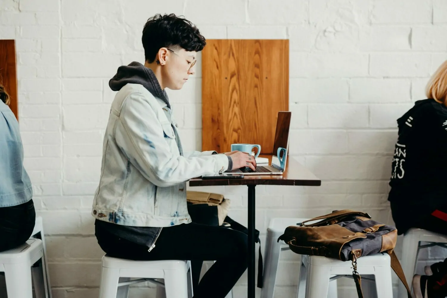 Female sat in a cafe working at a laptop using Dext Prepare