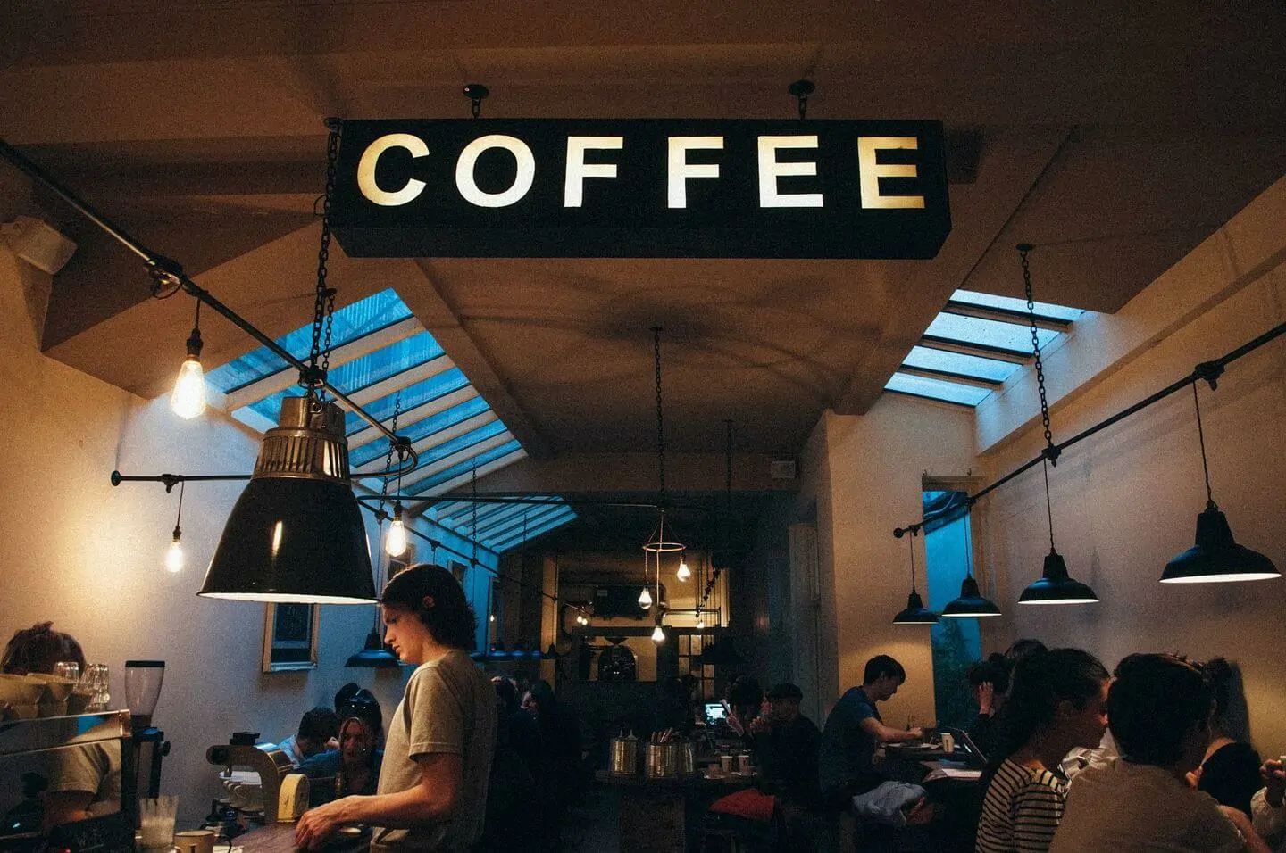 People in a café researching how to switch accountants