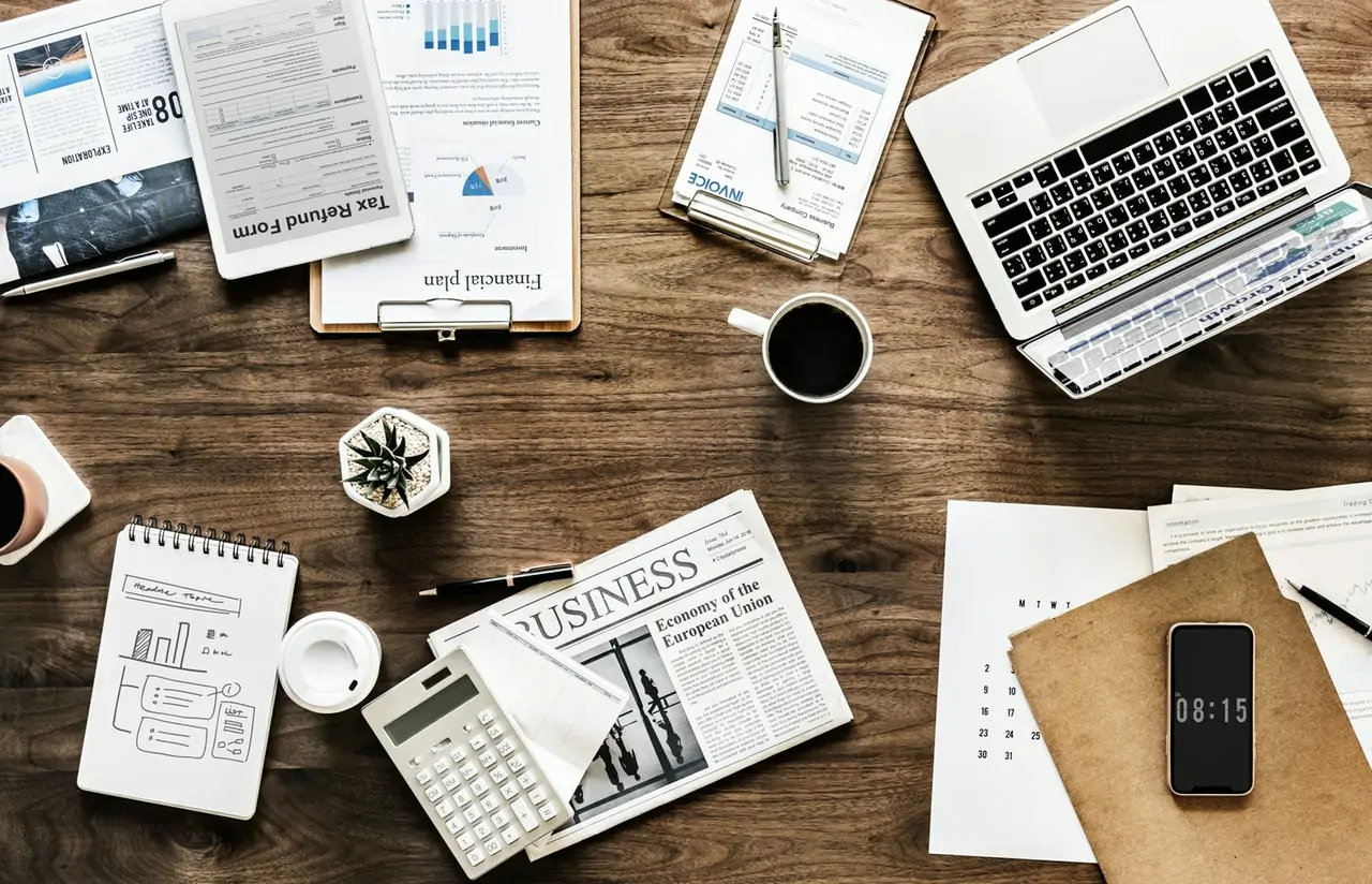 a cluttered desk as someone decides if they want to switch from a freelancer to business owner.